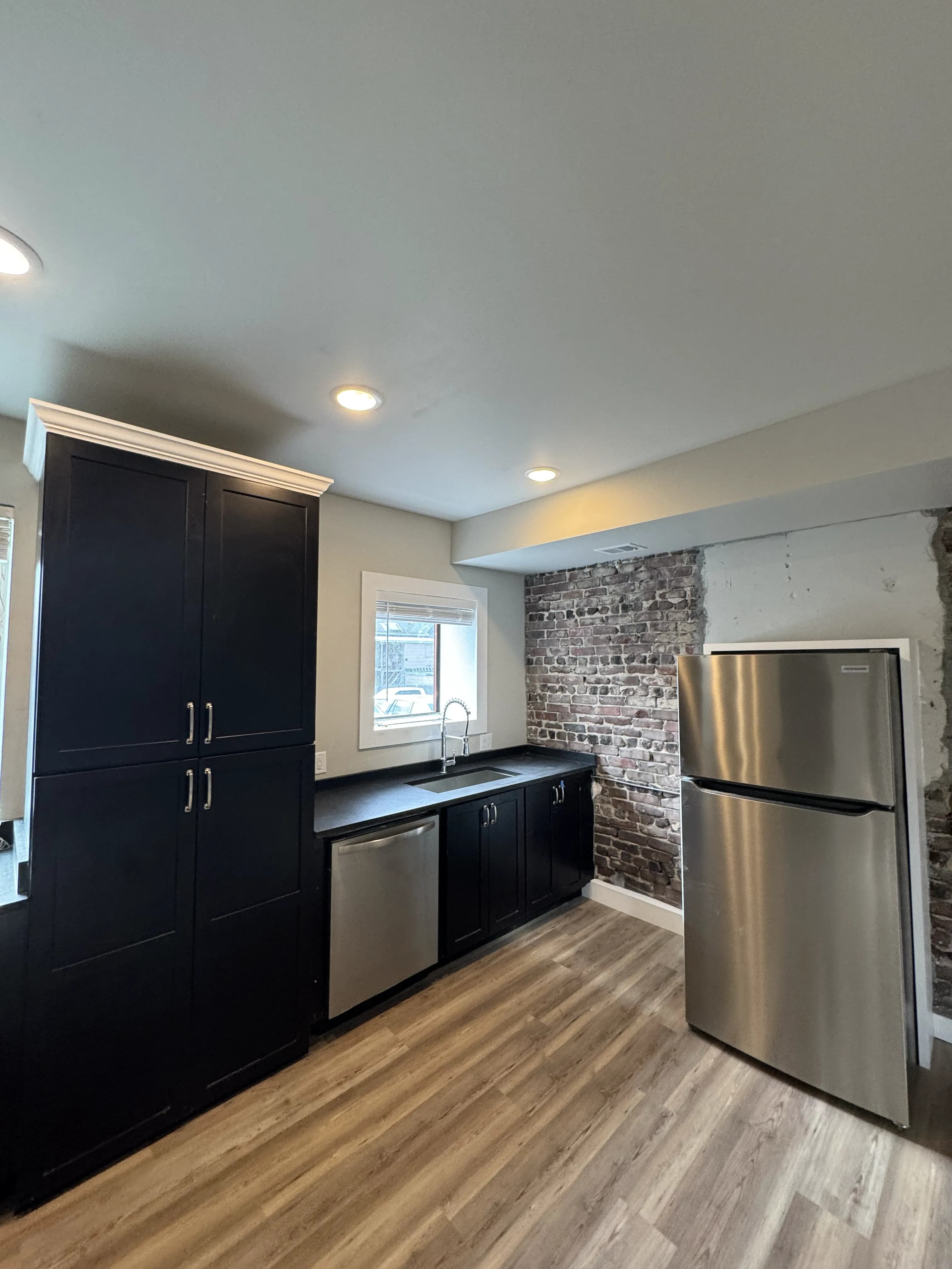 Furnished loft Unit 3 with exposed brick and high ceilings - Brick & Beam Lofts, Columbus Park, Kansas City
