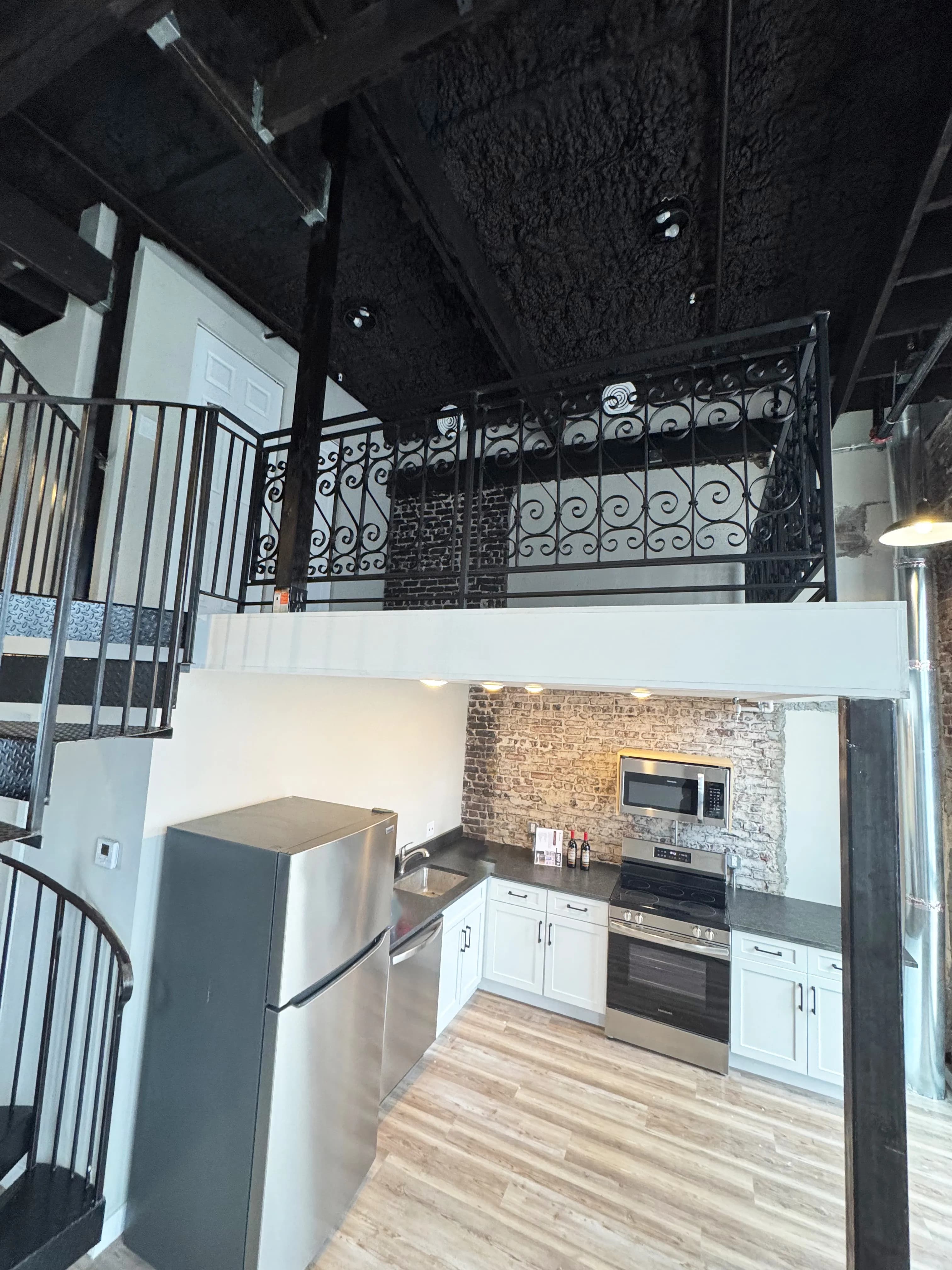 Furnished loft Unit 5 with exposed brick and high ceilings - Brick & Beam Lofts, Columbus Park, Kansas City