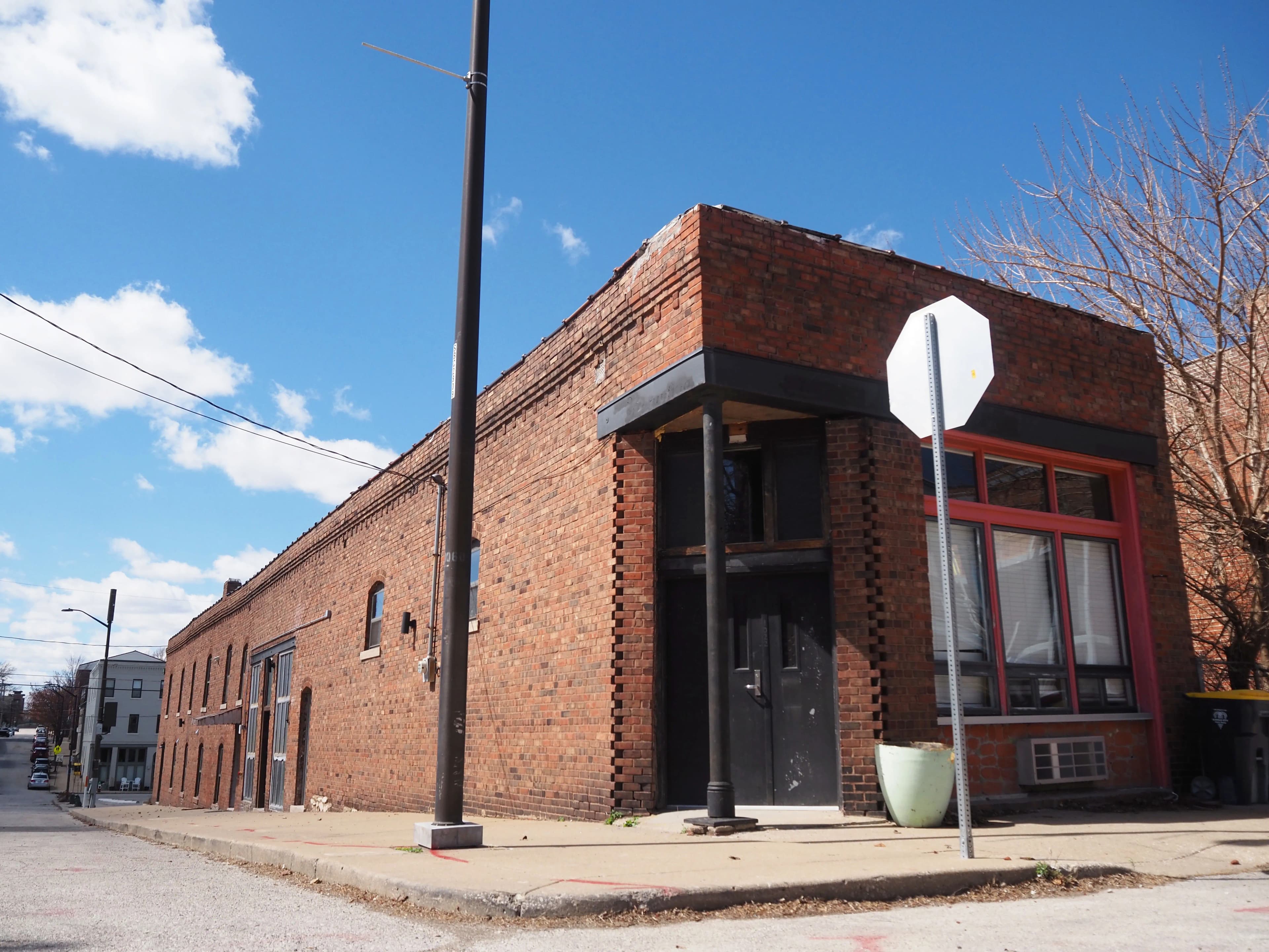 Furnished loft Unit 6 with exposed brick and high ceilings - Brick & Beam Lofts, Columbus Park, Kansas City